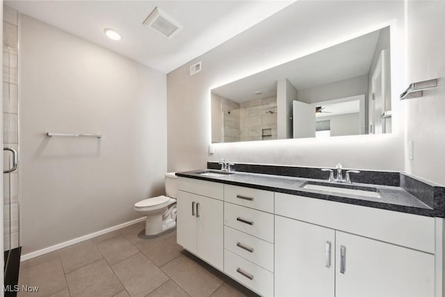 full bathroom featuring toilet, a stall shower, a sink, and visible vents