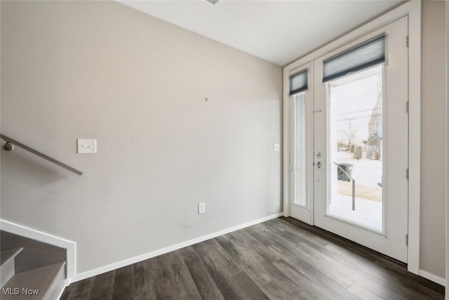 entryway with dark wood finished floors and baseboards