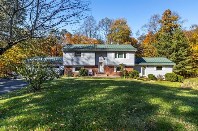 raised ranch featuring a front lawn