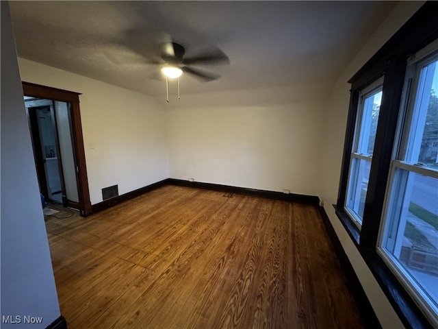 unfurnished room featuring hardwood / wood-style floors and ceiling fan