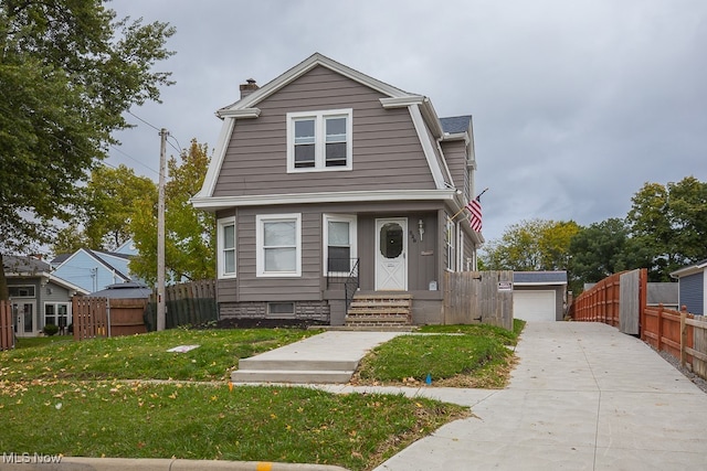 view of front of property with a front yard and a garage