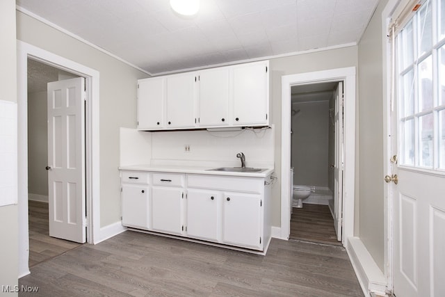 kitchen featuring white cabinets, hardwood / wood-style flooring, sink, and plenty of natural light