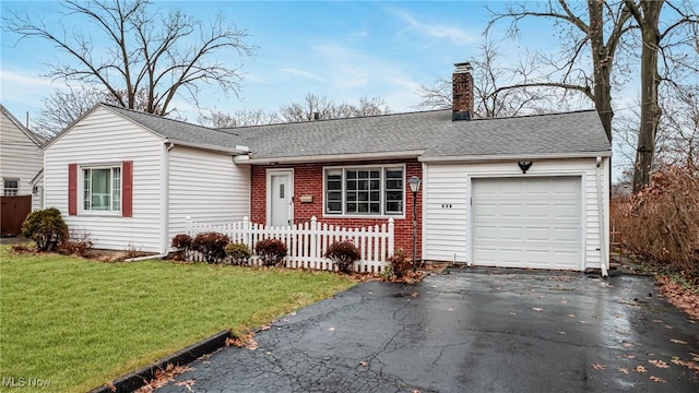 single story home featuring a garage and a front lawn