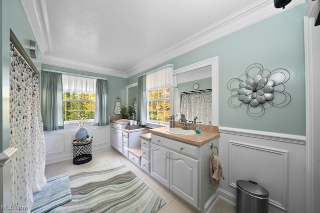 bathroom featuring crown molding, tile patterned floors, and vanity