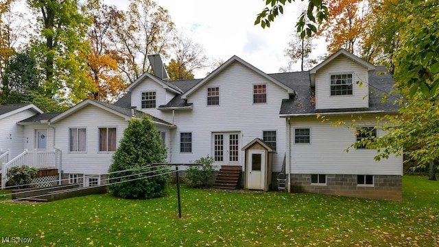 rear view of property featuring a yard