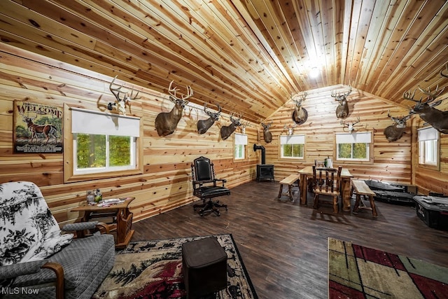 sitting room with hardwood / wood-style flooring, lofted ceiling, a wood stove, and wood ceiling