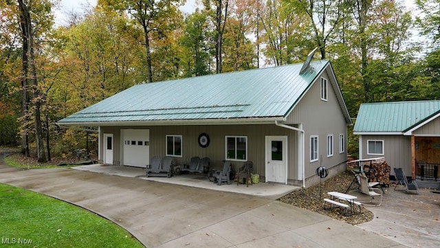 exterior space with a garage and an outdoor structure