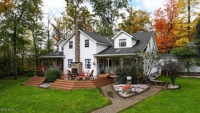 rear view of house featuring a lawn