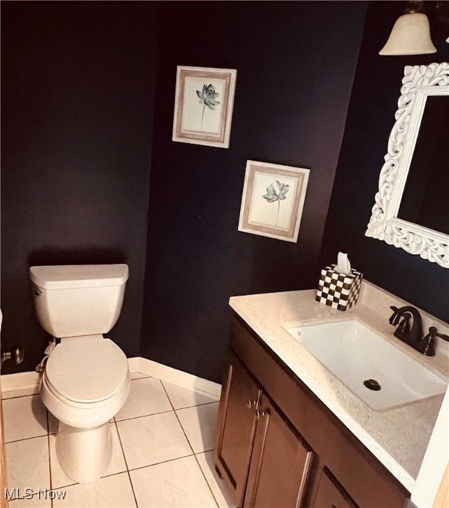 bathroom featuring tile patterned floors, toilet, and vanity