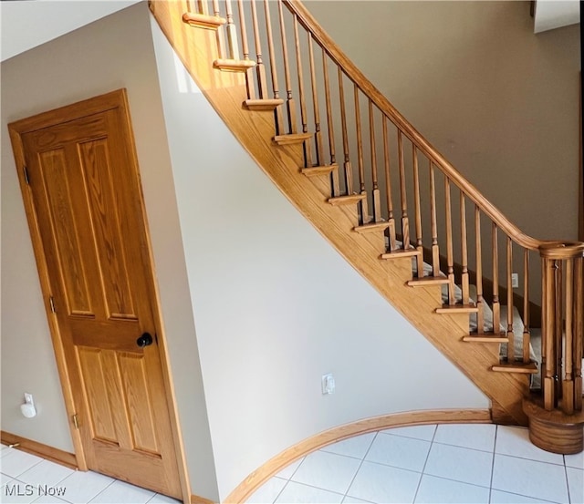 stairs featuring tile patterned floors