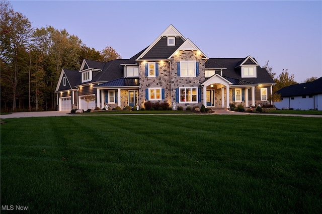 view of front of house with a yard and a garage