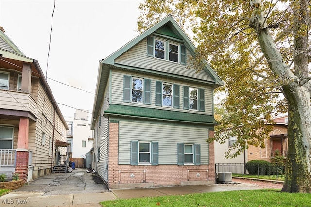 rear view of property with central AC