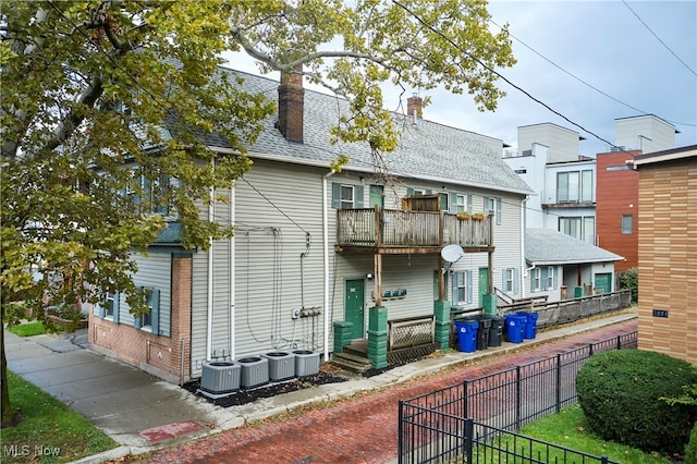 back of property with a balcony and cooling unit