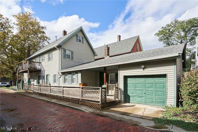 view of front of house featuring a garage and a balcony