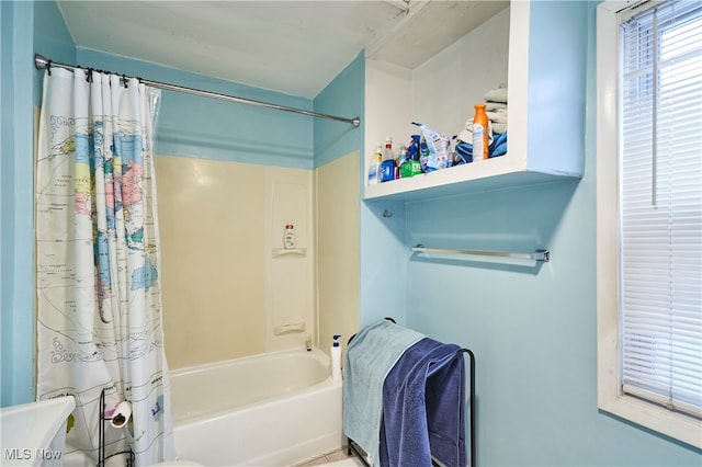 bathroom with toilet and shower / tub combo