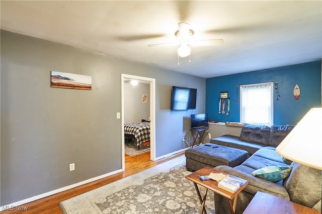 living room with hardwood / wood-style floors and ceiling fan