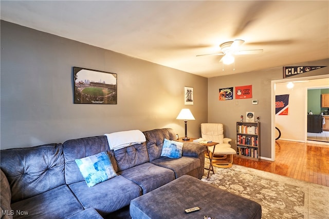 living room featuring ceiling fan and hardwood / wood-style floors