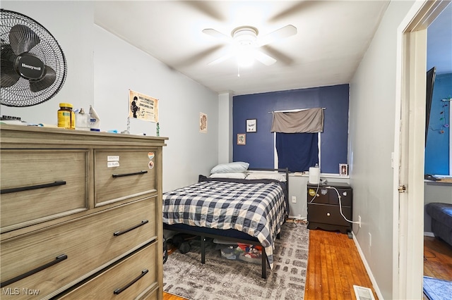 bedroom featuring ceiling fan and dark hardwood / wood-style floors