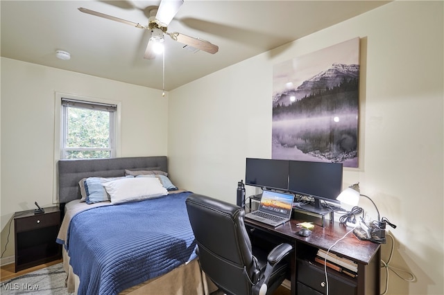 bedroom with light hardwood / wood-style flooring and ceiling fan