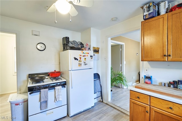 kitchen with light hardwood / wood-style flooring, white appliances, and ceiling fan