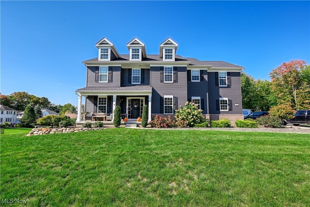 colonial inspired home featuring a front lawn and a porch