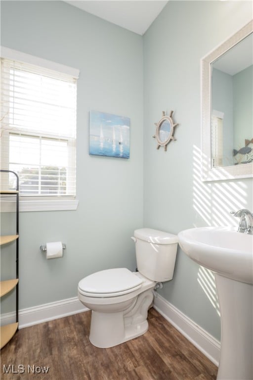 bathroom featuring toilet, hardwood / wood-style flooring, and sink