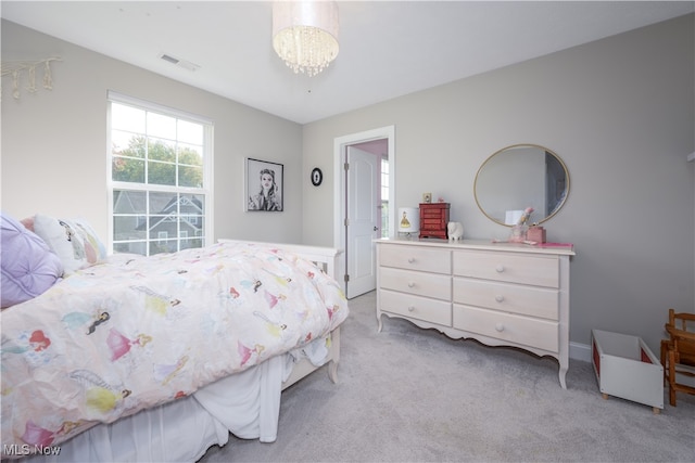 carpeted bedroom with a chandelier