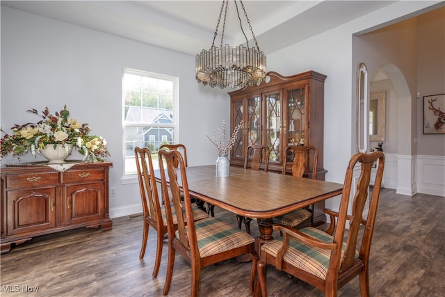 dining space featuring a notable chandelier and dark hardwood / wood-style flooring