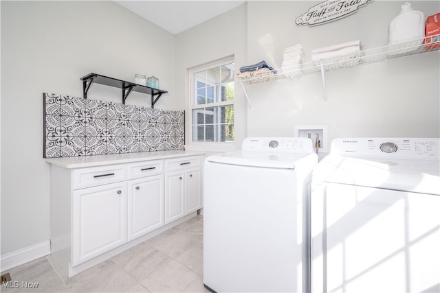 laundry area featuring cabinets, washer and clothes dryer, and light tile patterned floors