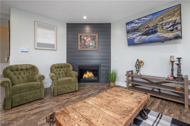 living area with hardwood / wood-style floors and a fireplace