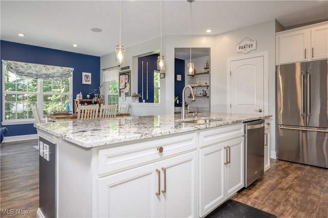 kitchen featuring appliances with stainless steel finishes, white cabinetry, sink, and dark wood-type flooring