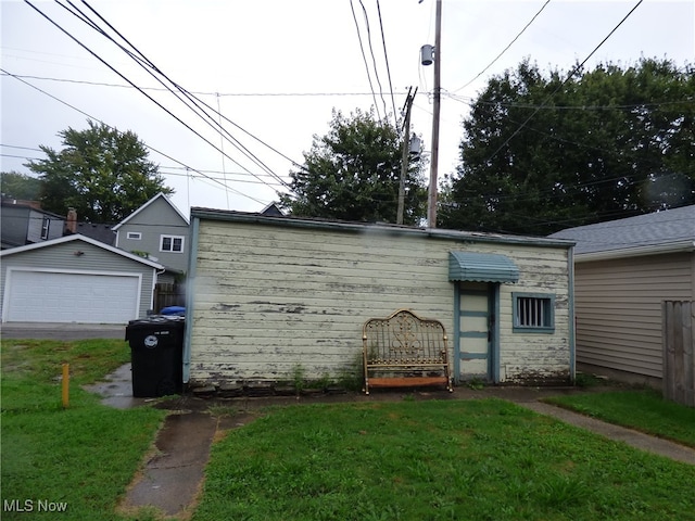 view of property exterior with a yard and a garage