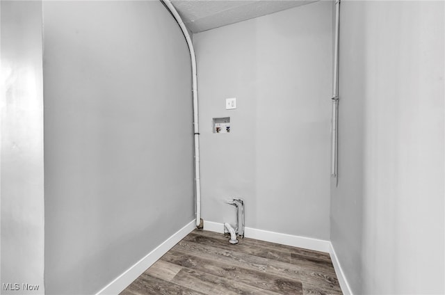 clothes washing area with washer hookup and dark hardwood / wood-style flooring