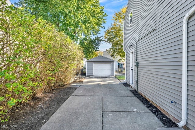 view of side of home with an outdoor structure and a garage