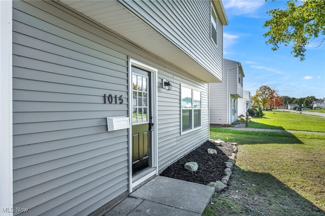 property entrance with a yard