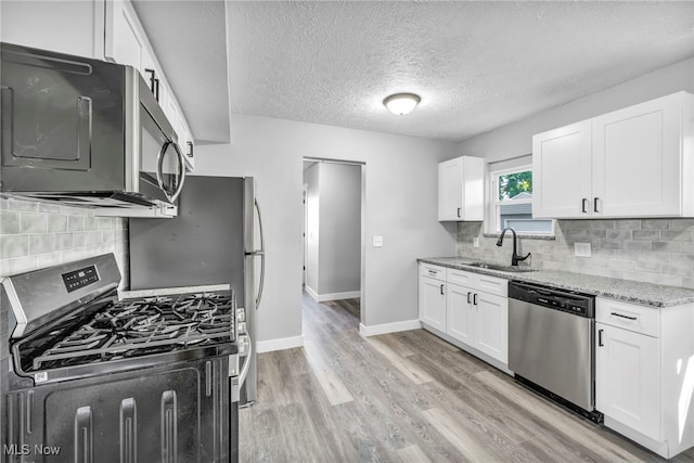 kitchen featuring sink, white cabinets, and stainless steel appliances