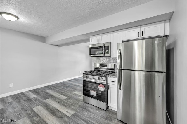 kitchen featuring stainless steel appliances, backsplash, white cabinets, a textured ceiling, and dark hardwood / wood-style flooring