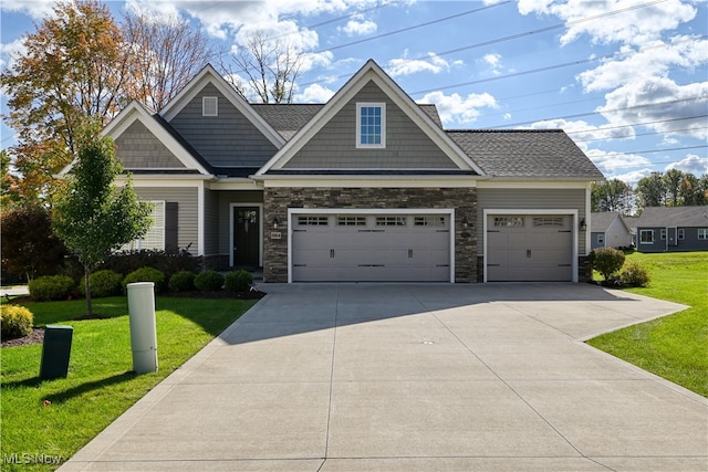 craftsman house featuring a front yard and a garage