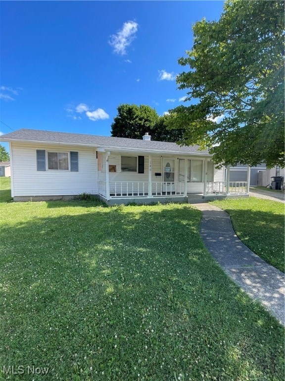 ranch-style house with a front yard and covered porch