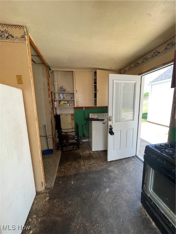 kitchen with washer / dryer and black range with gas stovetop