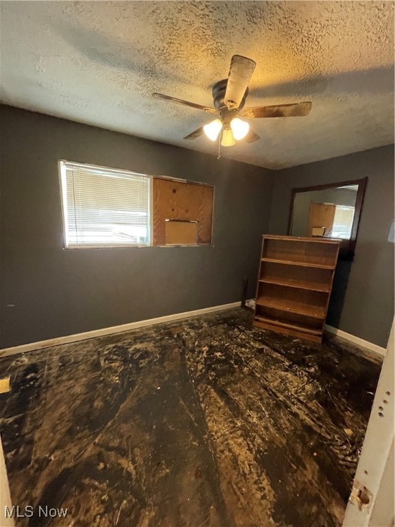 bedroom with a textured ceiling and ceiling fan