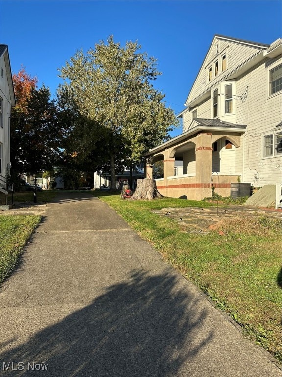 view of side of property featuring central air condition unit