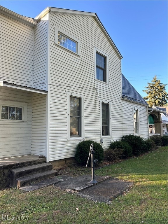 rear view of house with a yard