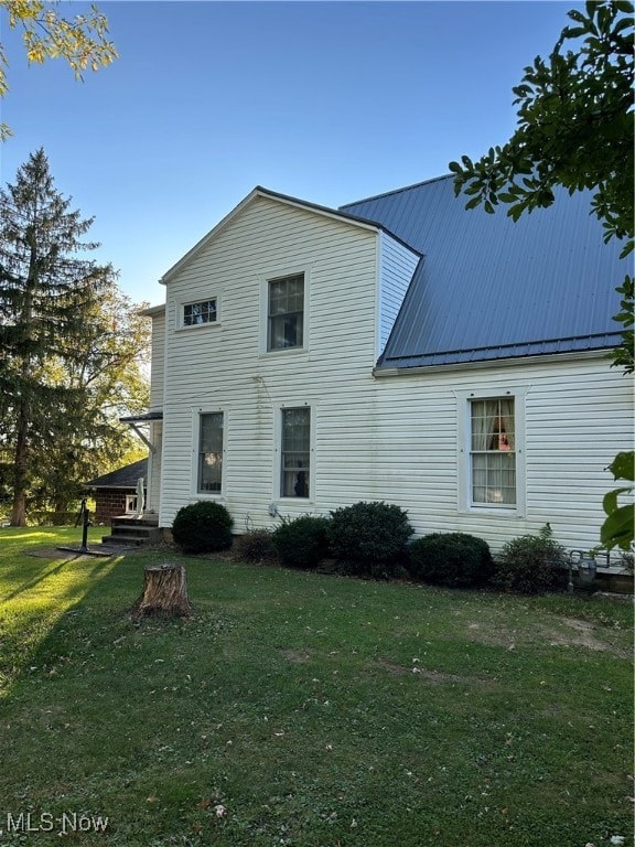 rear view of house with a lawn