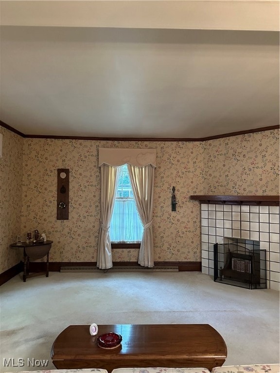 unfurnished living room featuring ornamental molding, carpet, and a tiled fireplace