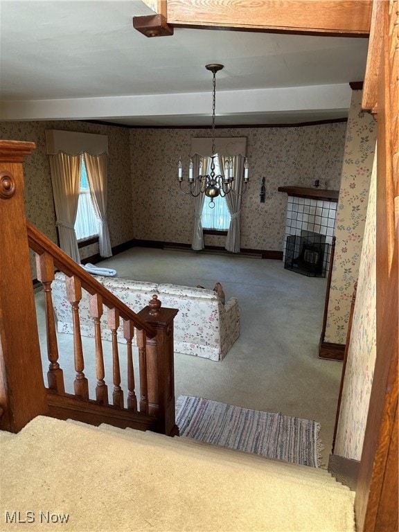 stairway featuring an inviting chandelier and carpet floors