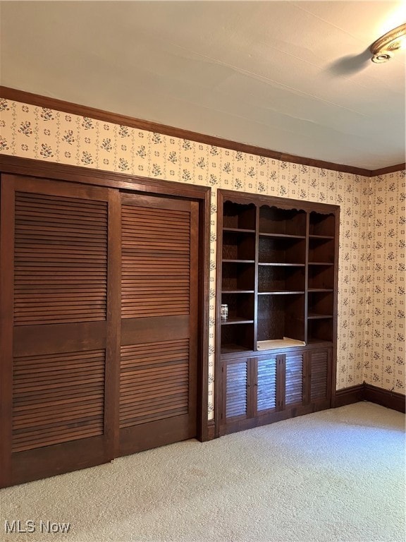 interior space with light carpet and crown molding