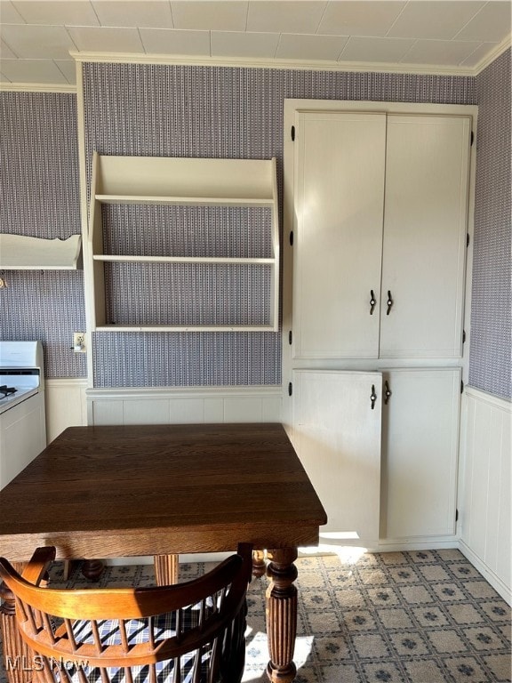 unfurnished dining area featuring crown molding