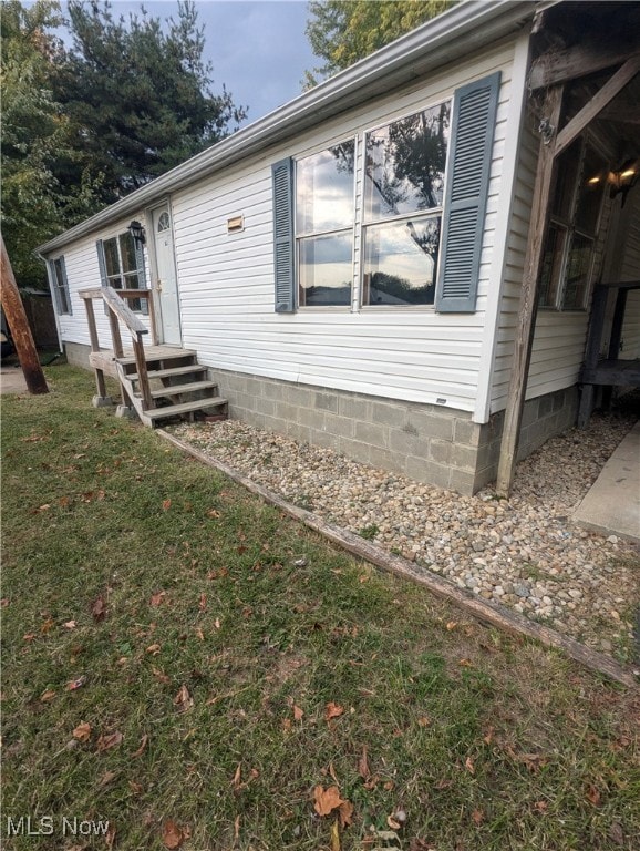 view of side of property with a lawn