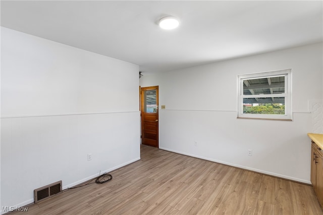 unfurnished room with light hardwood / wood-style flooring